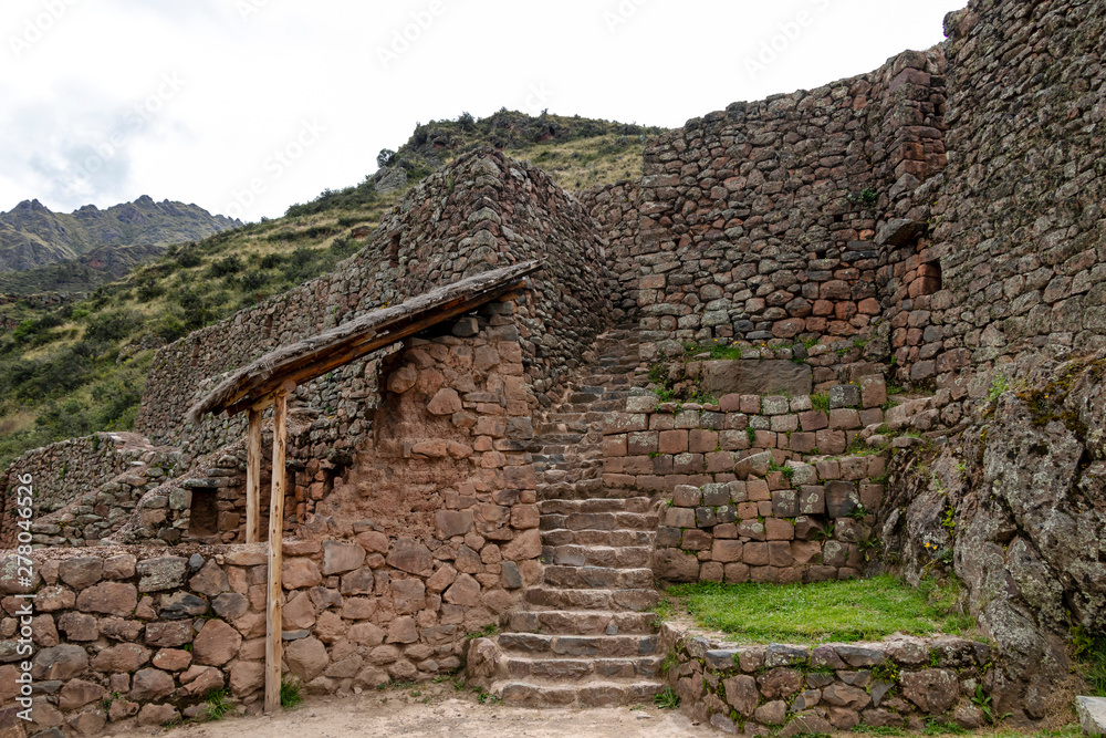 Inca ruins in Pisac archeological site surrounded by green peruvian Andes mountains, Sacred valley of the Incas, Peru