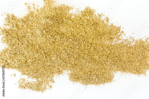 Golden glitter sparkle texture on white background.