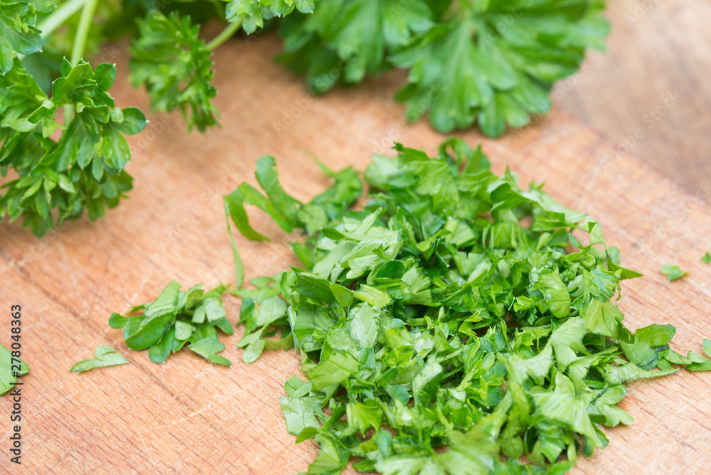 chopped parsley leaves on cutting board chopped parsley leaves on cutting board