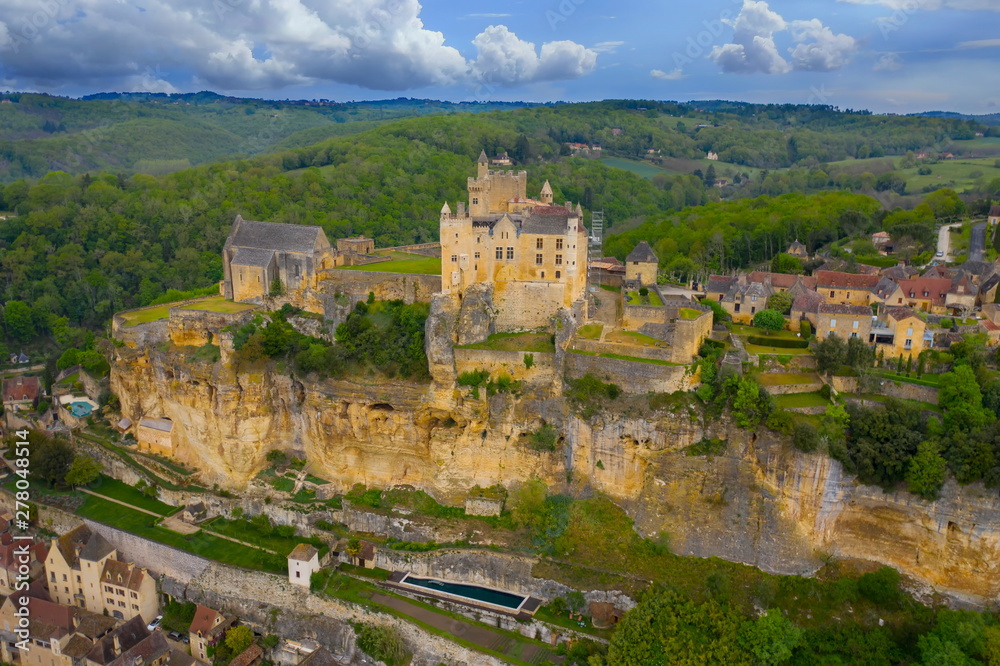 Aerial landscape. Ancient medieval Castle of Beynac stands on a top of a hill over the Dordogne river.  Beynac et Cazenac is a village labelled Most beautiful villages of France. 