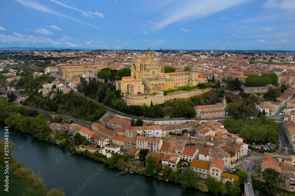 Aerial view of Beziers city: Saint Nazaire Cathedral, river and bridges. A landscape from France.