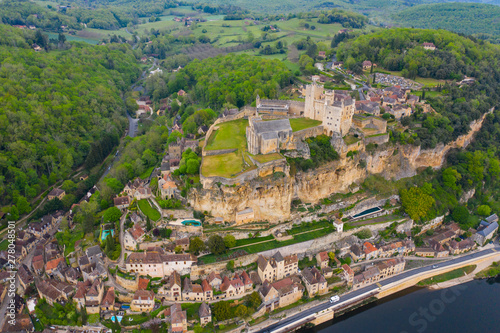 Aerial landscape. Ancient medieval Castle of Beynac stands on a top of a hill over the Dordogne river.  Beynac et Cazenac is a village labelled Most beautiful villages of France.  photo