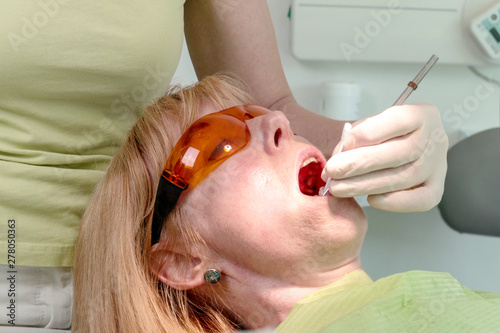 Dentist use a anesthetic oral gel to numb the area around tooth before injection