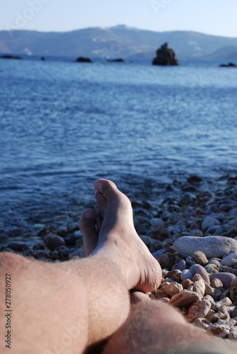 Feet at the beach at Patmos Island in Greece