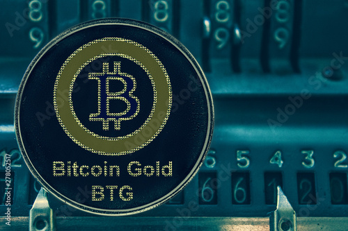 Coin Bitcoin gold btg against the numbers of the arithmometer. Crypto com chain photo