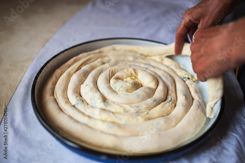Female hands preparing traditional homemade pie