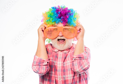 Enjoying playtime. happy birthday. corporate party. Crazy man in playful mood. happy man with beard. Celebration retirement. anniversary holiday. mature bearded man in colorful wig and party glasses