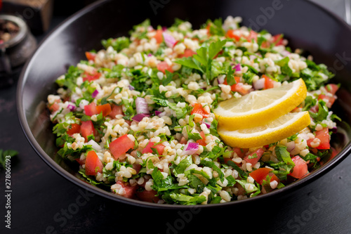 Tabbouleh salad. Traditional middle eastern or arab dish. Levantine vegetarian salad with parsley, mint, bulgur, tomato. photo