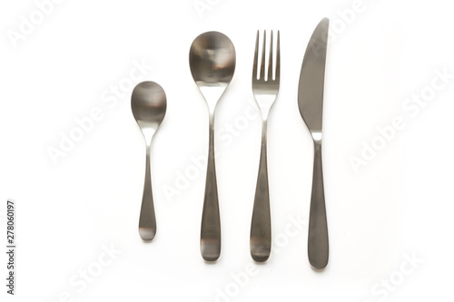 Set of metal elegance and traditional silverware  knife  fork  spoon  tea spoon on white background. Top view.