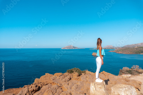 girl on a high cliff above the sea