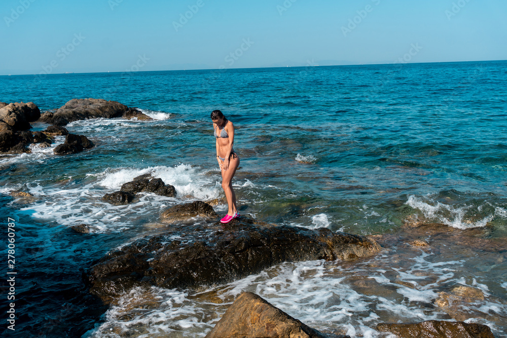 young girl having fun in sea summer time