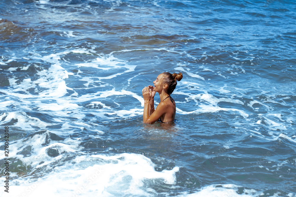 Cute young girl having fun in sea summer time