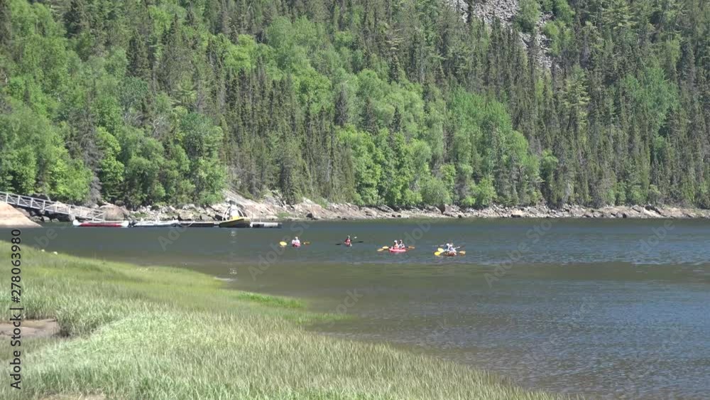 Kayaks on the lake, surrounded by mountains. Kayaks on the lake, surrounded by mountains.