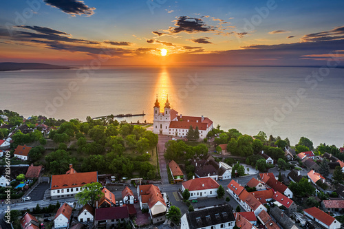 Obraz na płótnie Tihany, Hungary - Aerial skyline view of the famous Benedictine Monastery of Tihany (Tihany Abbey) with beautiful colourful sky and clouds at sunrise over Lake Balaton w salonie