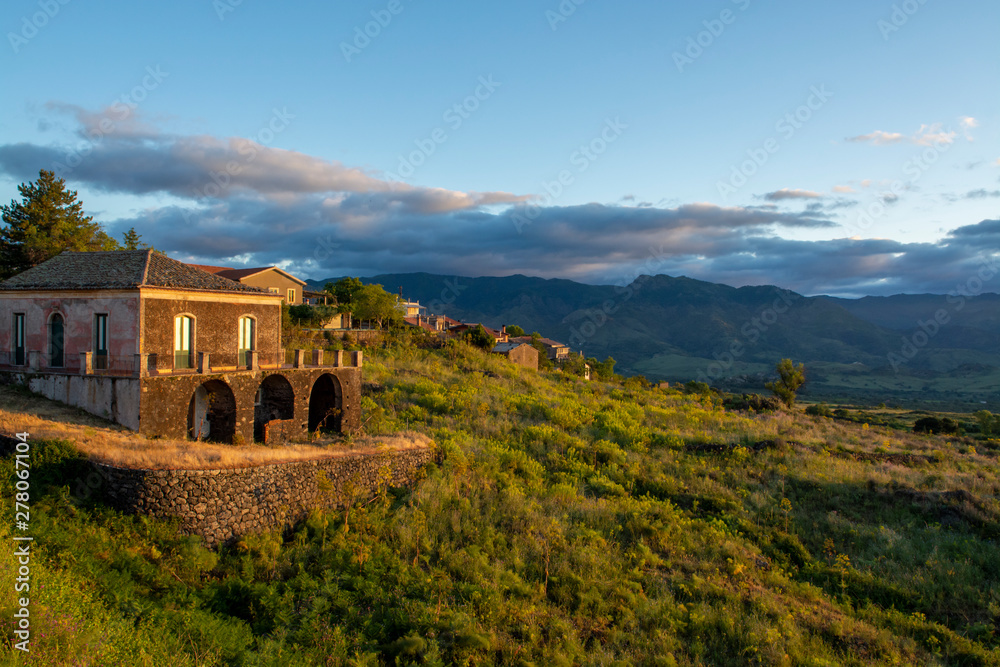 Landscape with old house and mountain range in soft morning sunlights on Sicily island, South of Italy