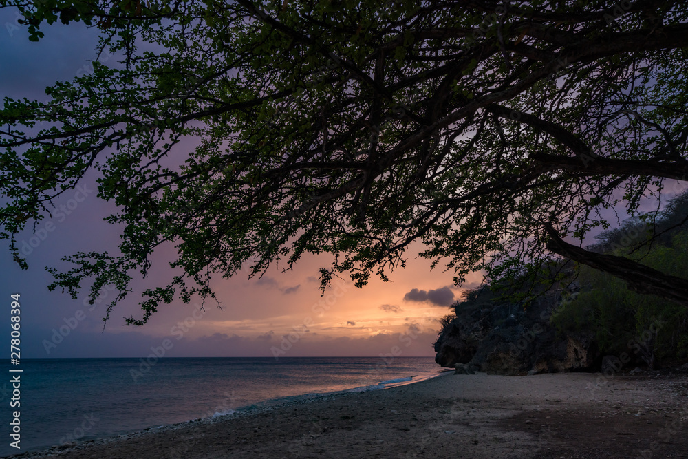 A fantastic sunset at the beach with a bonfire and BBQ on the island of Curacaio A fantastic sunset at the beach with a bonfire and BBQ on the island of Curacaio