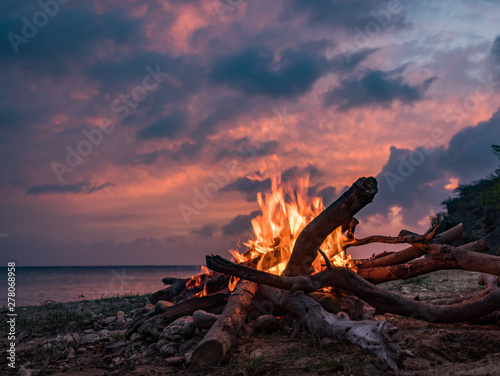 Fototapeta Naklejka Na Ścianę i Meble -  A fantastic sunset at the beach with a bonfire and BBQ on the island of Curacaio