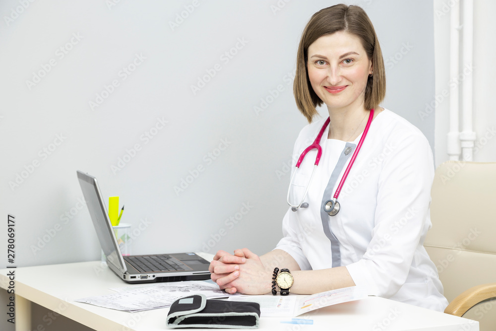 girl doctor at the table with a laptop girl doctor at the table with a laptop