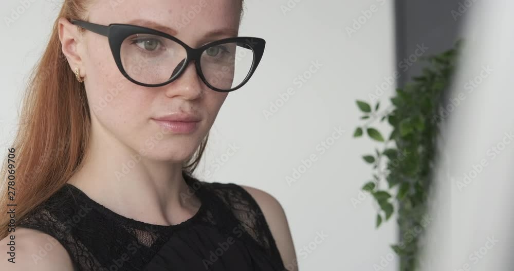 Young businesswoman writing on office whiteboard Young businesswoman writing on office whiteboard