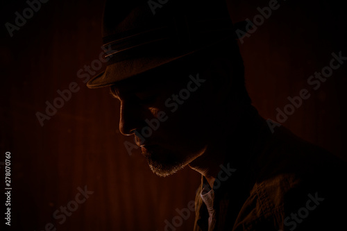 low key portrait of man with borsalino type hat photo