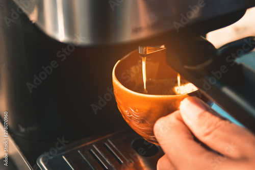 Espresso pouring from coffee machine. Barista Cafe Making Coffee Preparation Service Concept  Close-up