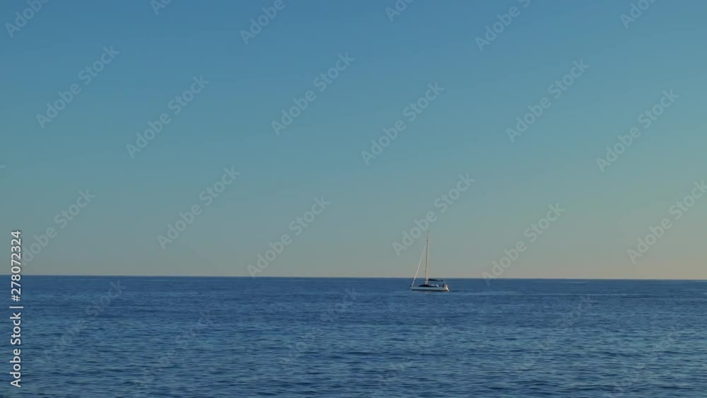 Ships far out in a sea leaving water trails under sunlight on deep blue sea water background. Ships, boats and vessels on a horizon. Sunny summer day, clear blue sky. Wind and waves. Ships far out in a sea leaving water trails under sunlight on deep blue sea water background. Ships, boats and vessels on a horizon. Sunny summer day, clear blue sky. Wind and waves.