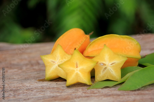 Carambola or star apple ( starfruit ) on old wooden background,Close up healthy carambola or star apple food . 