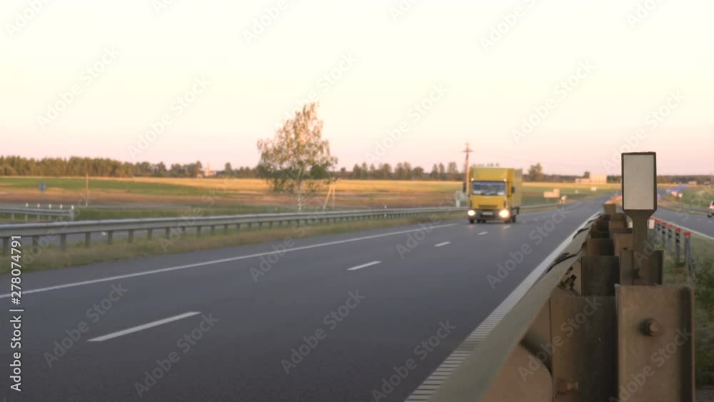 Modern wagon truck transports cargo against the backdrop of a sunset. The concept of truck drivers in the field of freight and logistics, copy space, commercial Modern wagon truck transports cargo against the backdrop of a sunset. The concept of truck drivers in the field of freight and logistics, copy space, commercial