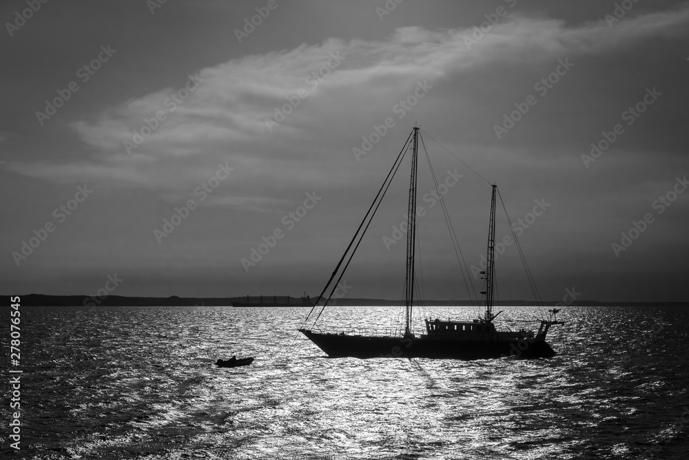 Backlit photo of a sailing ship sailing in the ocean