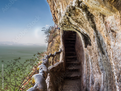 Path to climb Xishan mountain in Kunming (China) with view on the lake. photo