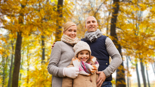 family, childhood, season and people concept - happy family in autumn park