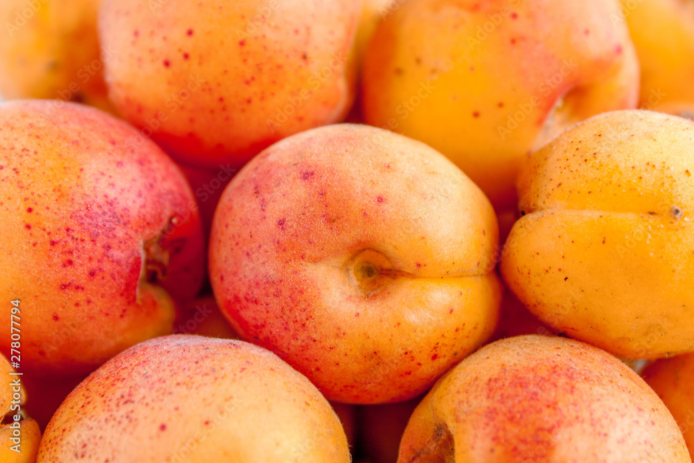 Background from a variety of ripe juicy orange apricots closeup. E Background from a variety of ripe juicy orange apricots closeup. E