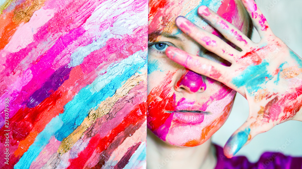 Fototapeta premium Artist woman concept. Paint on face of young woman artist