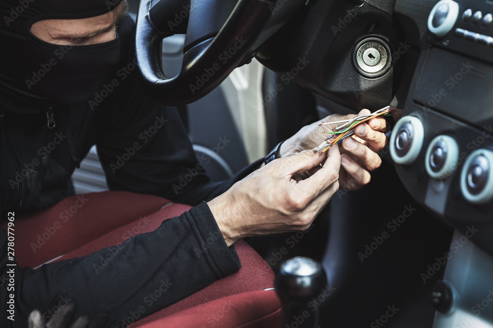 car hotwire - thief try to steal a vehicle by connecting ignition wires car hotwire - thief try to steal a vehicle by connecting ignition wires