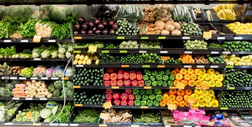 Vegatables of assorted varieties on display in a modern grocery store.