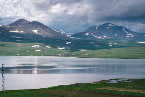 Fototapeta Naklejka Na Ścianę i Meble -  Lake Paravani in Georgia, Caucasus. The largest lake in Georgia at an altitude of more than 2000 meters. Low rain clouds.