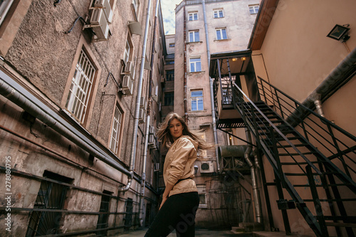 Beautiful girl with long hair walks around the city © viktoria_koks