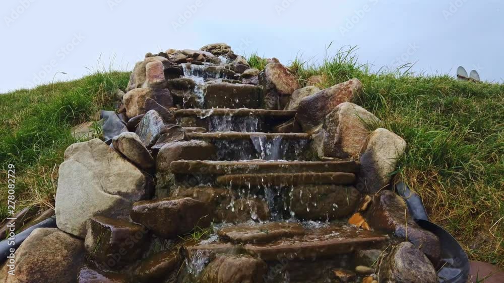 Beautiful cascading waterfall fountain made from natural stone Beautiful cascading waterfall fountain made from natural stone
