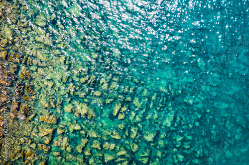 Aerial view of rocky stones in the sea