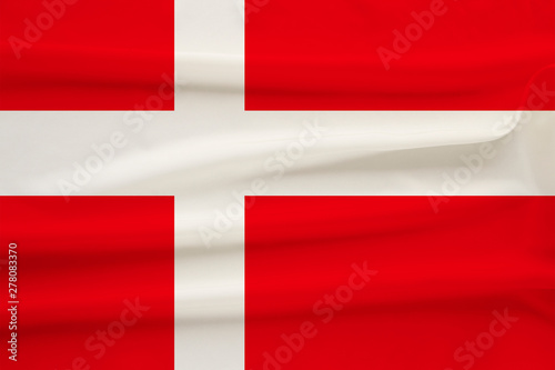 Free Download The national flag of the country of Denmark on the gentle silk with folds from the wind, the concept of travel, immigration, politics, copy space, close-up - GFXLoad