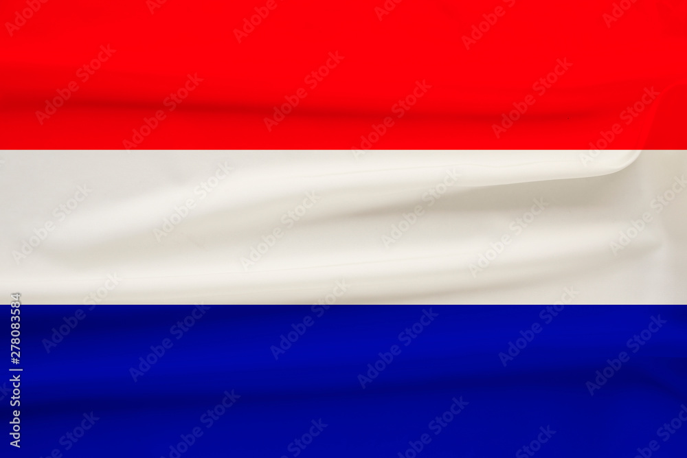 national flag of the country Holland on gentle silk with wind folds, travel concept, immigration, politics, copy space, close-up national flag of the country Holland on gentle silk with wind folds, travel concept, immigration, politics, copy space, close-up