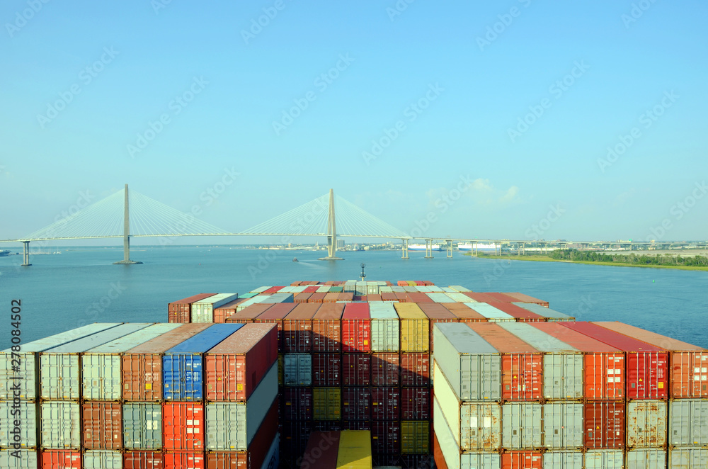 Fototapeta premium Kontenerowiec zbliżający się do mostu Arthur Ravenel Jr. w Charleston, South Caroline.