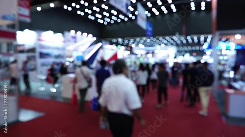 People walking in exhibition fair defocused background footage timelapse photo