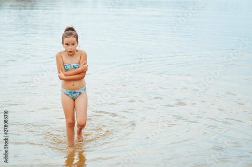 Slika na platnu Girl shivering after a swim in the freezing cold water