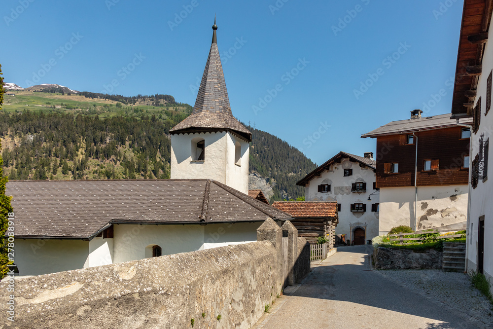 View of an old historic village with high mountains in the background in the swiss alps View of an old historic village with high mountains in the background in the swiss alps