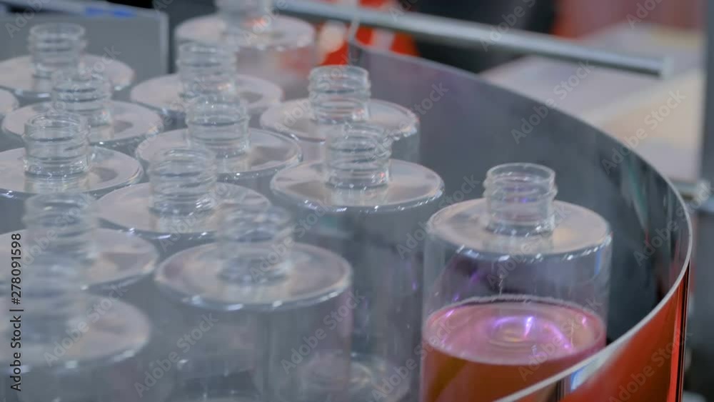 Pharmaceutical industry, manufacturing, medicine, sample, sale and automated technology equipment concept - rotating platform with empty glass bottles at pharmaceutical exhibition or pharmacy store Pharmaceutical industry, manufacturing, medicine, sample, sale and automated technology equipment concept - rotating platform with empty glass bottles at pharmaceutical exhibition or pharmacy store