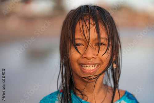 beach lifestyle portrait of young beautiful and happy 7 or 8 years old Asian American mixed child girl with wet hair enjoying holidays playing in the sea having fun