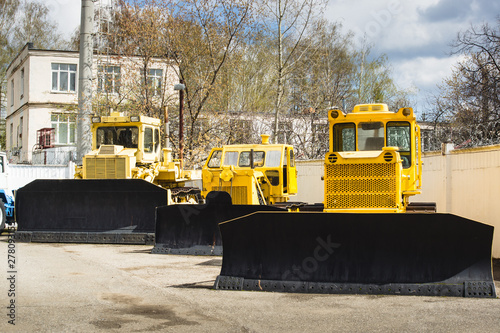 yellow industrial tractors in the factory's yard