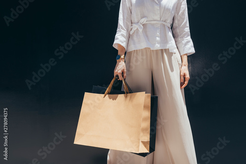 Unrecognisable stylish woman holding shopping bags.