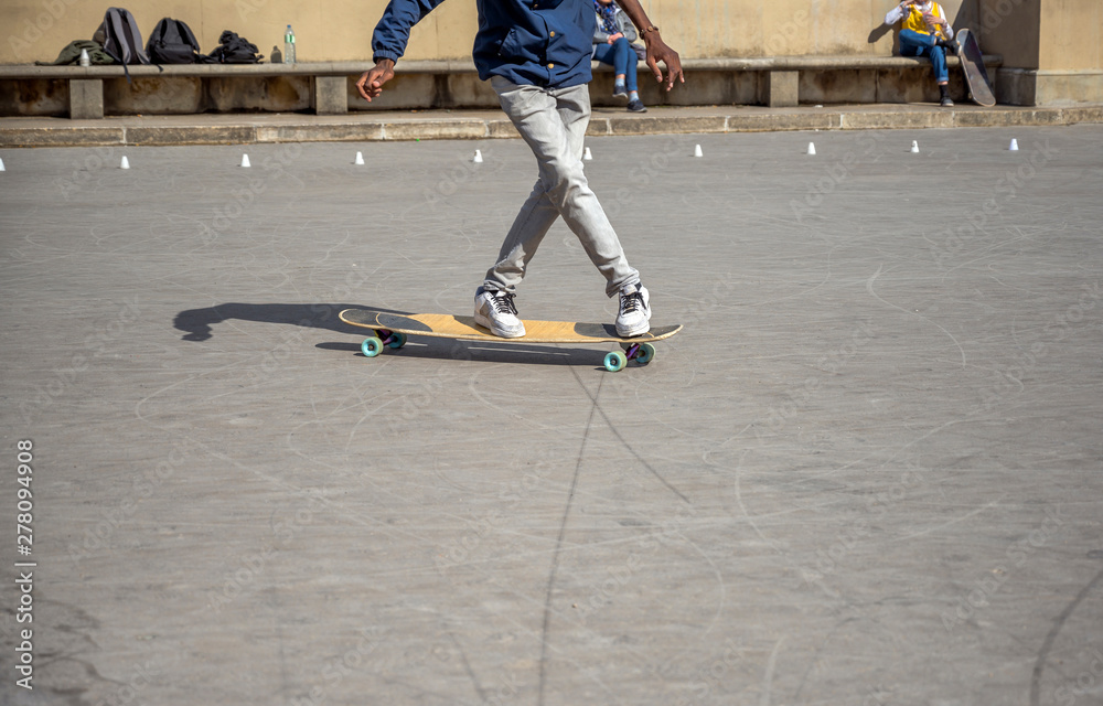 Fototapeta premium The guy writes pirouettes on skateboard on special area for exercise